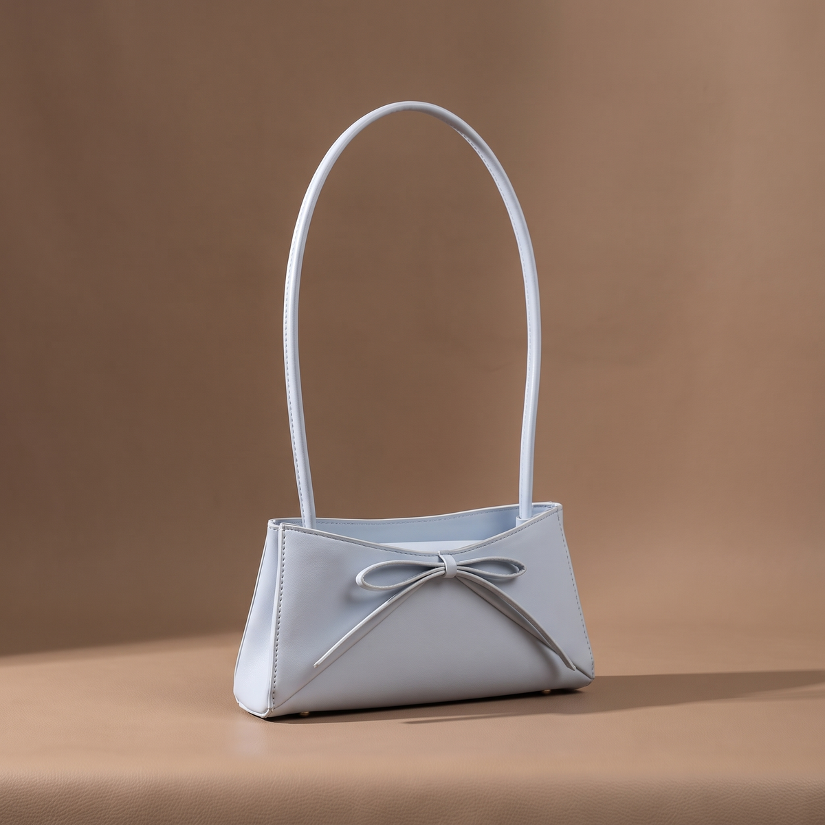 Women's light blue structured shoulder bag with bow detail
